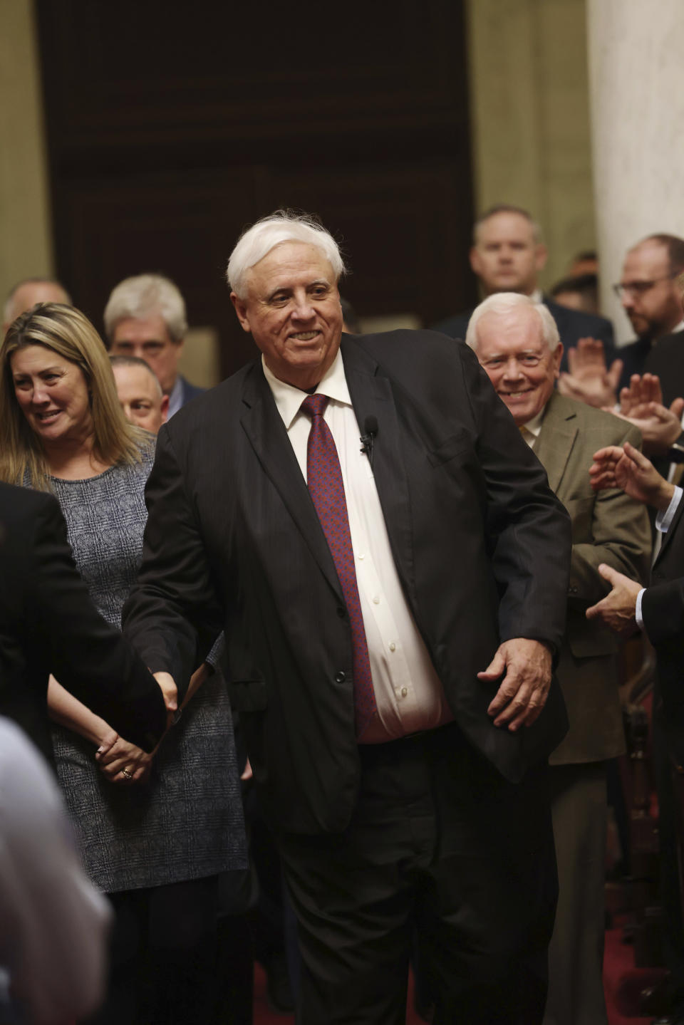 West Virginia Gov. Jim Justice enters the House Chamber prior to giving his annual State of the State address in the House Chambers at the state capitol in Charleston, W.Va., on Wednesday, Jan. 11, 2023. (AP Photo/Chris Jackson)