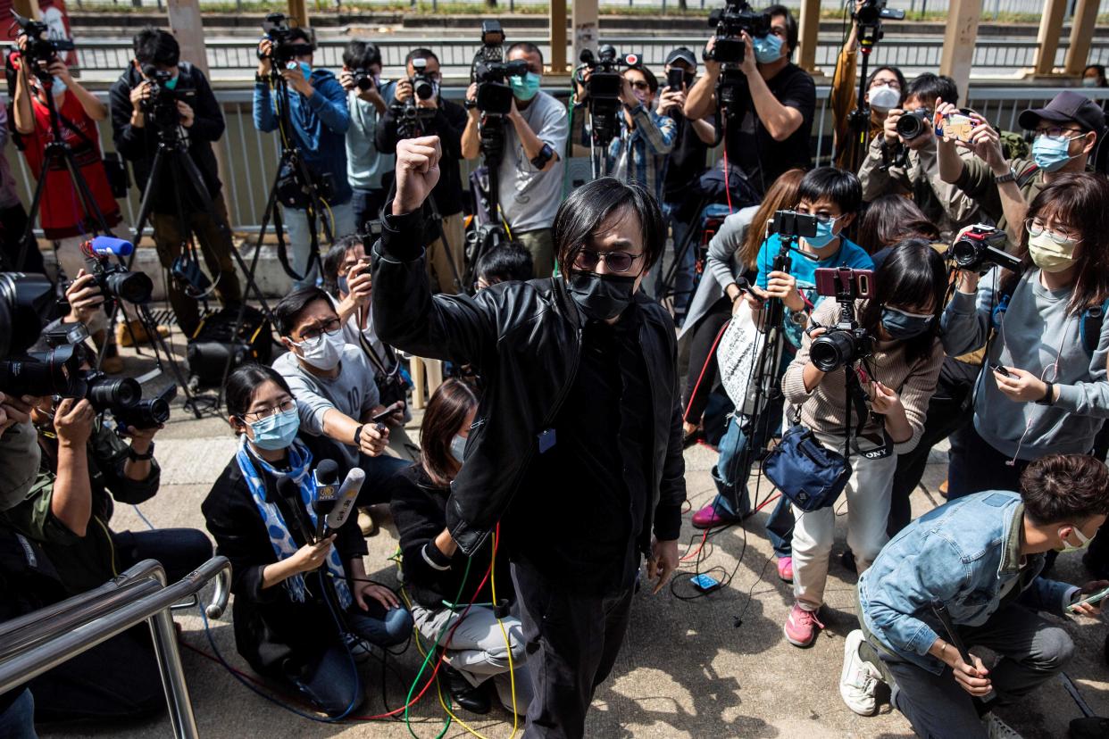 <p>Hong Kong pro-democracy activist Mike Lam gestures after speaking with the press outside Ma On Shan police station in Hong Kong where he and 46 other dissidents were each charged with one count of 