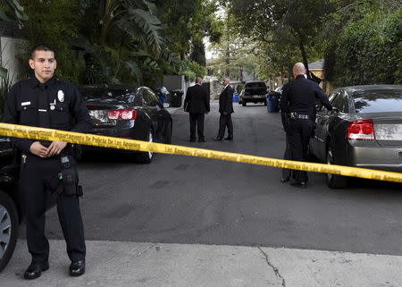 Los Angeles Police Department officers and investigators gather on a street leading to the house of Andrew Getty, 47, the grandson of Getty oil founder J. Paul Getty, in the Hollywood Hills section of Los Angeles, California March 31, 2015. REUTERS/Kevork Djansezian