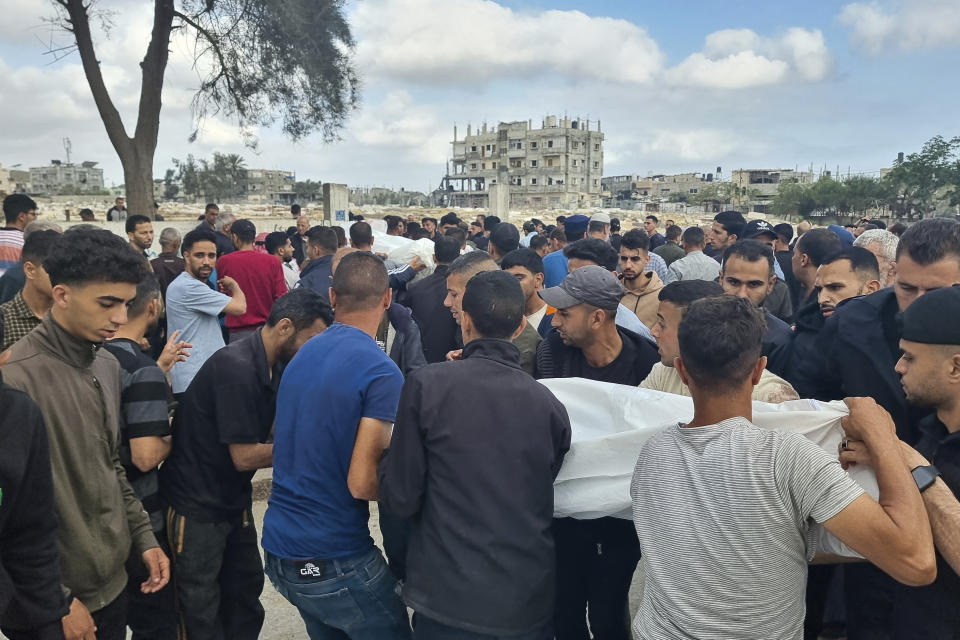 Mourners carry the bodies of members of the Abu Taha family who were killed in an Israeli airstrike, during their funeral at Al-Salam cemetery, east of Rafah, Gaza Strip. Monday, April 29, 2024. (AP Photo/Mohammad Jahjouh)