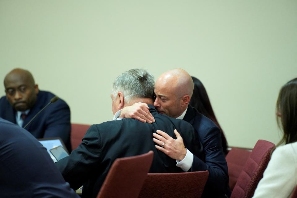 Attorney Luke Nikas hugs Alec Baldwin in the courtroom.