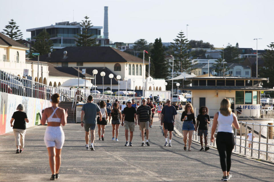 People walk along a path at Bondi Beach in Sydney, Australia.