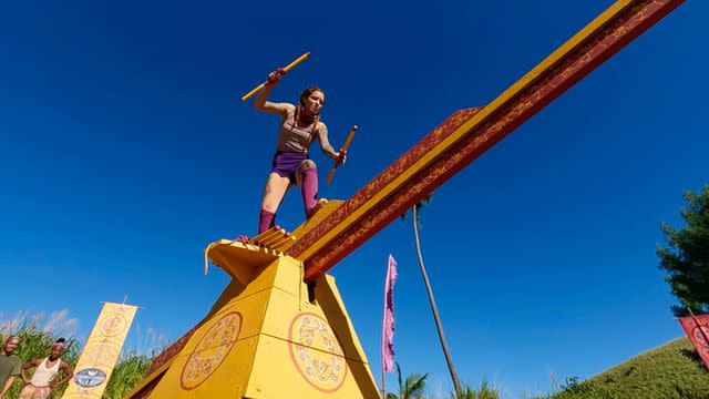 <p>CBS</p> Kenzie competes in round one of the immunity challenge.