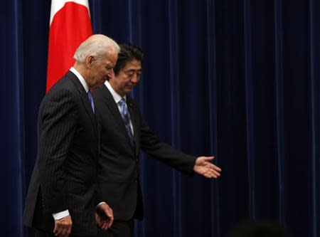 U.S. Vice President Joe Biden (L) is escorted by Japan's Prime Minister Shinzo Abe as they leave their joint news conference at the prime minister's official residence in Tokyo December 3, 2013. REUTERS/Toru Hanai