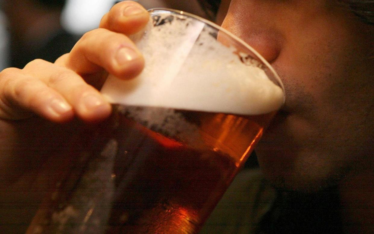 A man drinks a pint of beer