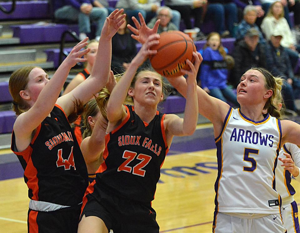 Sioux Falls Washington's Ava Brink (44) and Dana Harpe fight for a rebound against Watertown's Emery Thury during their high school girls basketball game on Friday, Feb. 2, 2024 in the Watertown Civic Arena. Washington won 46-41.