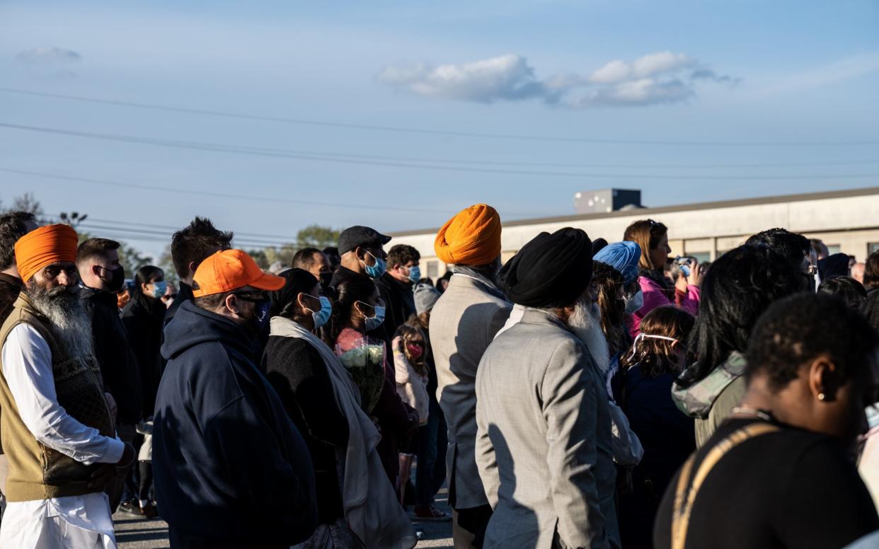 Mourners hold a vigil for the victims of the Indianapolis FedEx shooting - Jon Cherry/Getty