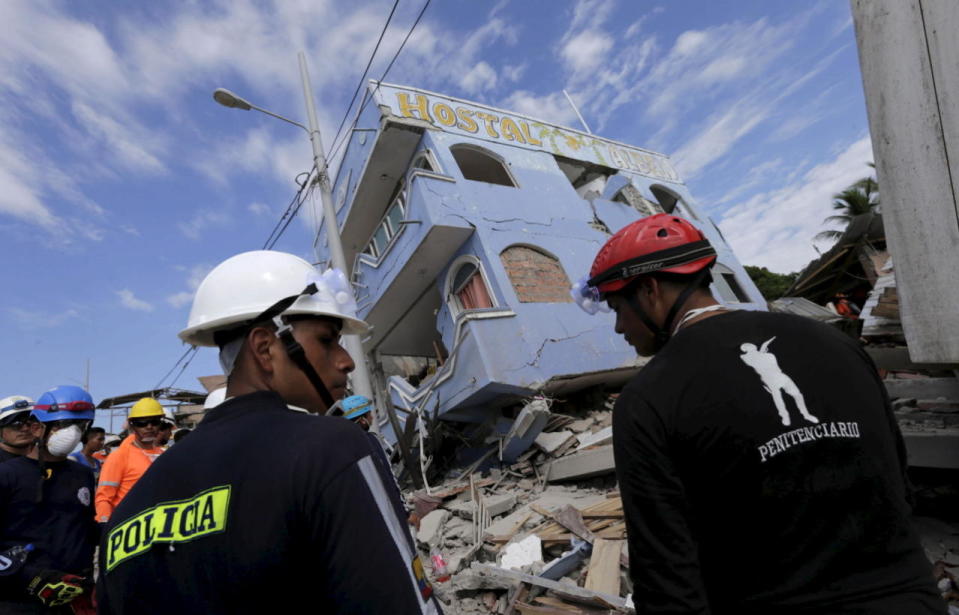 Standing guard next to a collapsed hotel