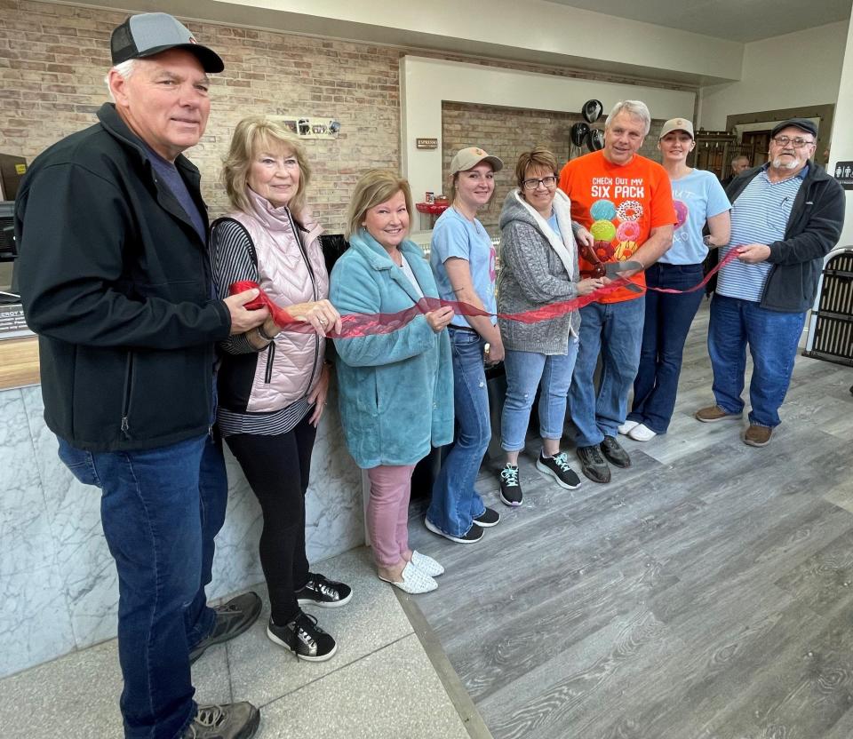 A ribbon cutting was held recently at the new Heavenly Sweets Bakery outlet in West Lafayette in the Brickstone Building. Participating are building owners Ed and Susan Myers, Amy Crown of the Coshocton County Chamber of Commerce, employee Samantha Hamilton, owners Jan and Deric Potts, employee Amanda Priest and Oren Griffith of the West Lafayette Chamber of Commerce.