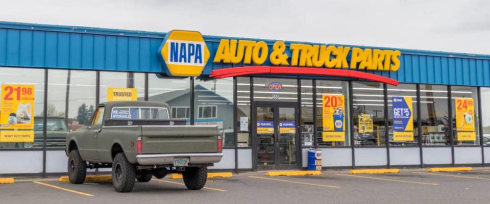 The exterior of a NAPA Auto Parts store in Portland, Oregon with a pickup truck parked out front