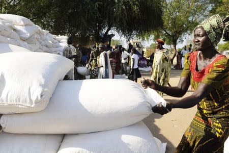 An internally displaced South Sudanese woman pulls a bag of cereal during a distribution by the World Food Programme in Bor, Jonglei state, in this file photo taken on December 10, 2014. REUTERS/Jok Solomon