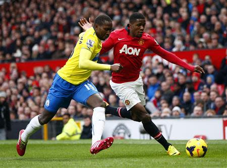 Manchester United's Wilfried Zaha (R) challenges Newcastle United's Mapou Yanga-Mbiwa during their English Premier League soccer match at Old Trafford in Manchester, northern England December 7, 2013. REUTERS/Darren Staples