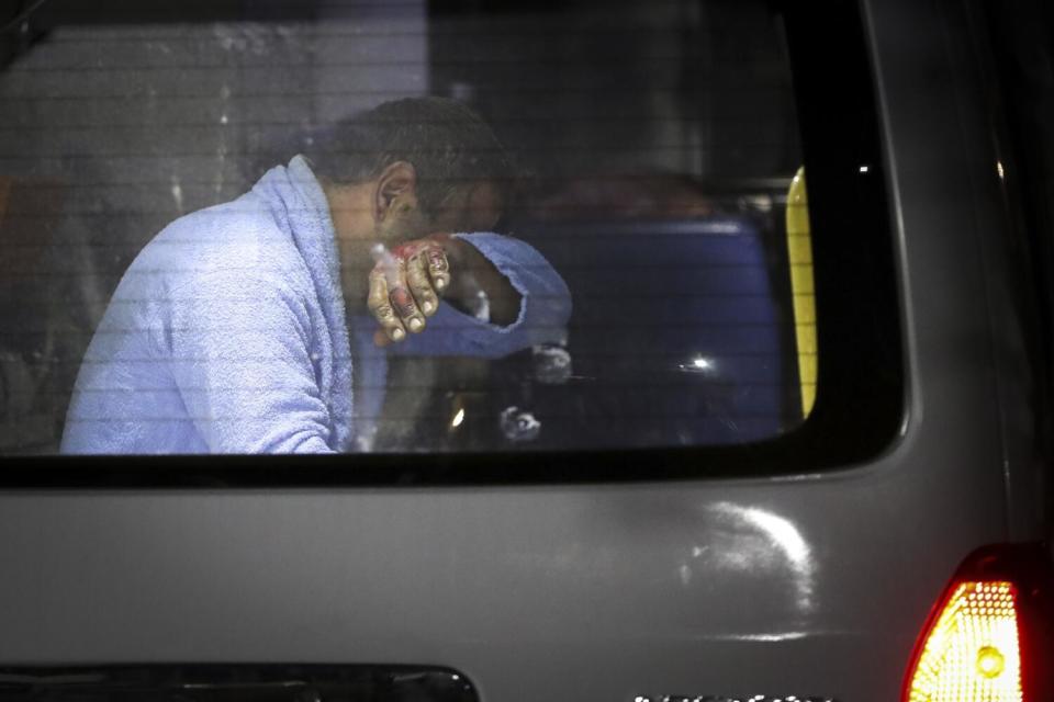 Man sitting in an ambulance after being injured during an explosion