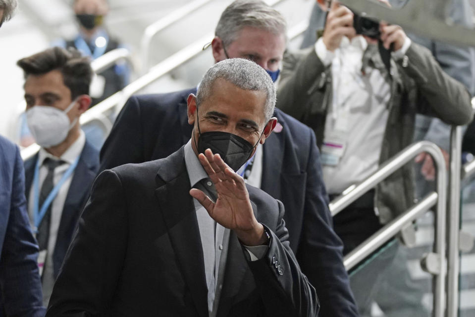 Former U.S. President Barack Obama waves as he arrives at an event during the COP26 U.N. Climate Summit in Glasgow, Scotland, Monday, Nov. 8, 2021. The U.N. climate summit in Glasgow is entering it's second week as leaders from around the world, are gathering in Scotland's biggest city, to lay out their vision for addressing the common challenge of global warming. (Jane Barlow/PA via AP)