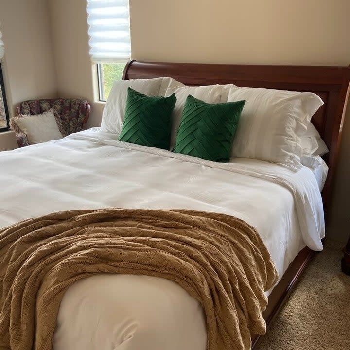 reviewer image of the white comforter on a bed