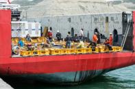 Workers weld the deck of the Sophie Siem ship, where US Navy personnel will install a capsule designed to rescue sailors trapped in the sunken submarine