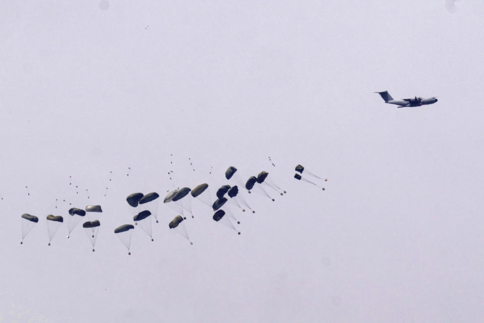 Parachutes drop supplies into the northern Gaza Strip, as seen from southern Israel, Wednesday, March 27, 2024. (AP Photo/Ohad Zwigenberg)