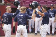 Dallas Baptist's Glenn Jackson, right, celebrates with Jace Grady (29) and River Town (14) after hitting a home run in the third inning during an NCAA college baseball tournament super regional game against Virginia on Monday, June 14, 2021, in Columbia, S.C. (AP Photo/Sean Rayford)