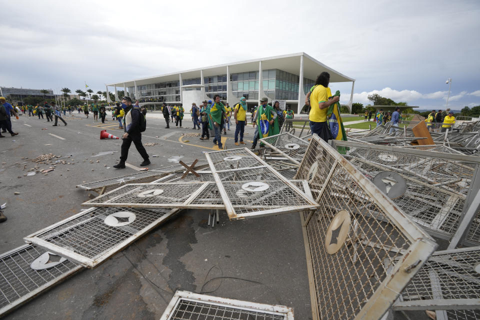 Protesters, supporters of Brazil's former President Jair Bolsonaro, storm the Planalto Palace in Brasilia, Brazil, Sunday, Jan. 8, 2023. Planalto is the official workplace of the president of Brazil. (AP Photo/Eraldo Peres)