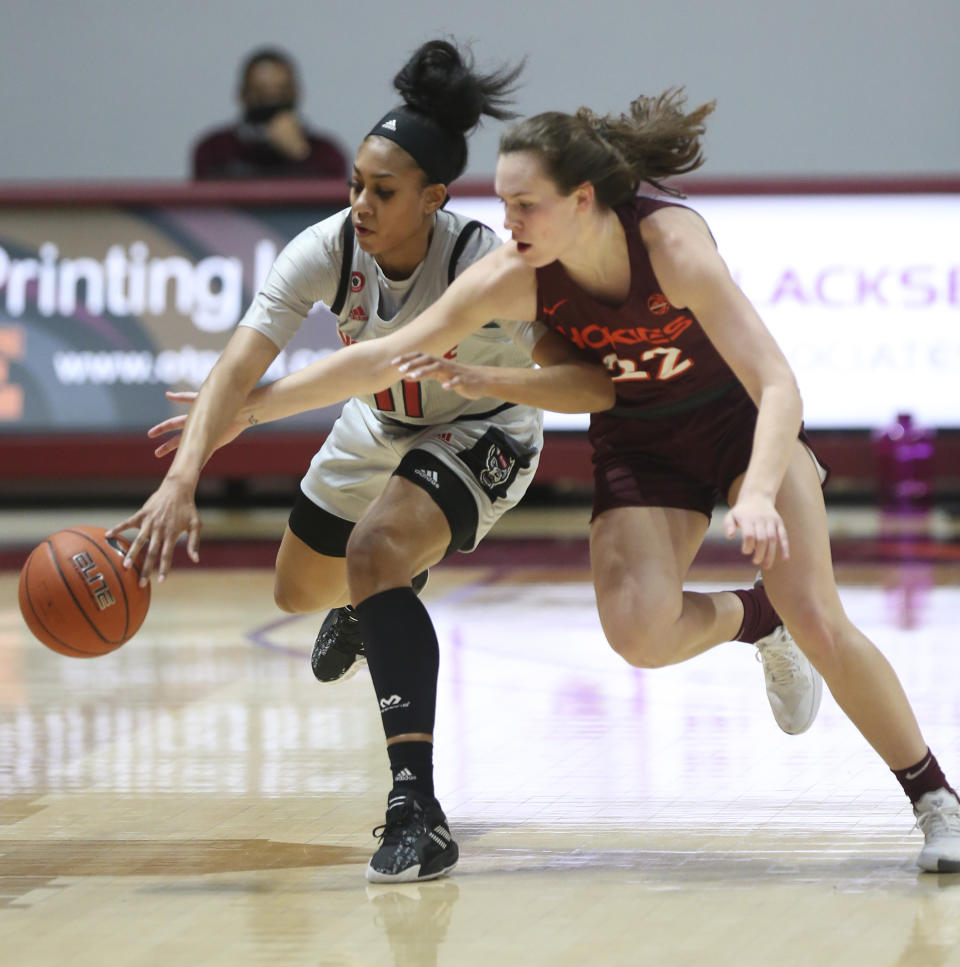 North Carolina State's Jakia Brown-Turner (11) and Virginia Tech's Cayla King (22) compete for a rebound during the first half of an NCAA college basketball game in Blacksburg, Va., Thursday, Jan. 28, 2021. (Matt Gentry/The Roanoke Times via AP, Pool)
