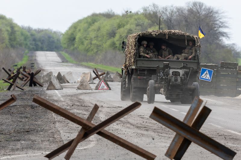 A Ukrainian military vehicle drives to the front line during a fight, amid Russia's invasion in Ukraine, near Izyum