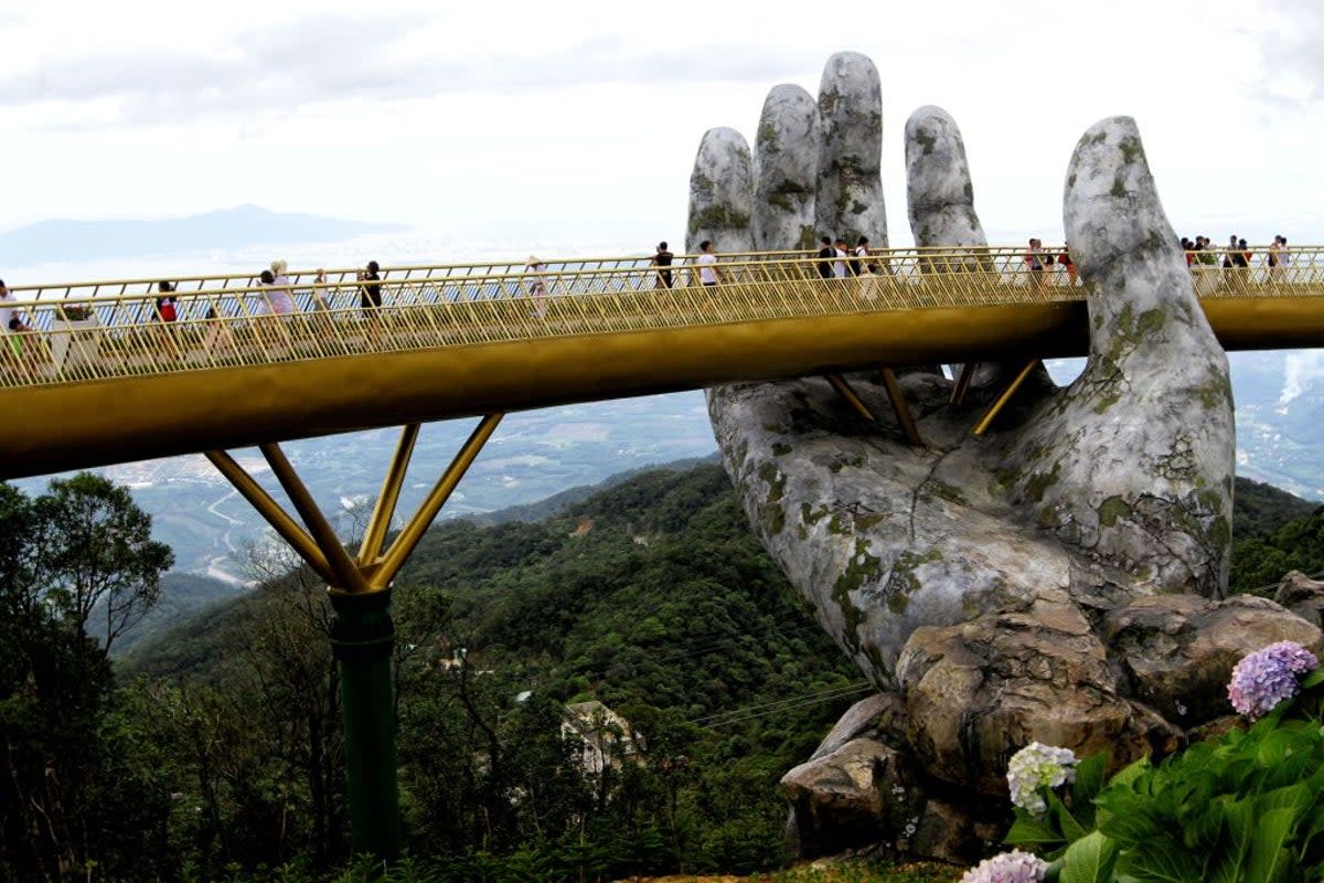 Tourists are flocking to see the giant hands on the Golden Bridge (AFP/Getty Images)