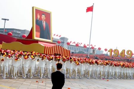 Float carrying a portrait of late Chinese President Xi Jinping moves through Tiananmen Square during the parade marking the 70th founding anniversary of People's Republic of China, on its National Day in Beijing