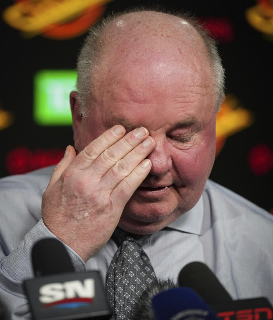 Vancouver Canucks coach Bruce Boudreau wipes his eye during a news conference after the team's NHL hockey game against the Edmonton Oilers on Saturday, Jan. 21, 2023, in Vancouver, British Columbia. (Darryl Dyck/The Canadian Press via AP)