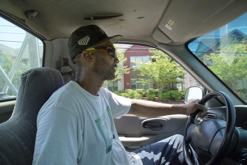 Alton Lucas drives home after dropping some firewood at a local convenience store outside of Raleigh, N.C., on Friday, June 18, 2021. “I started the landscaping company, to be honest with you, because nobody would hire me because I have a felony,” said Lucas, whose business got off the ground with the help of Inmates to Entrepreneurs, a national nonprofit assisting people with criminal backgrounds by providing practical entrepreneurship education. (AP Photo/Allen G. Breed)