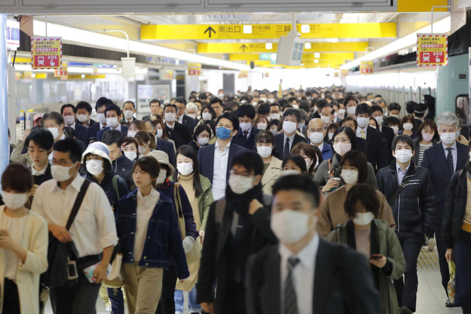 Commuters wear masks at a station in Fukuoka, southern Japan Wednesday morning, April 8, 2020. Japan’s Prime Minister Shinzo Abe declared a month-long state of emergency Tuesday for Tokyo and six other prefectures including Fukuoka to ramp up defenses against the spread of the coronavirus as the number of infections surges. (Kyodo News via AP)