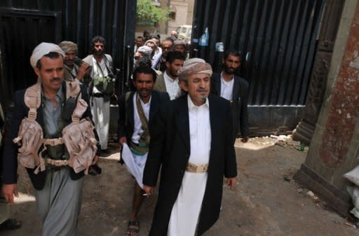 Yemeni tribal leader Sadiq al-Ahmar (C) is flanked by armed guards as he walks out of his residence in the al-Hasaba neighbourhood of north Sanaa. Security forces in the Yemeni capital battled heavily armed supporters of the country's most powerful tribal leader on Thursday as President Ali Abdullah Saleh ordered the tribesman's arrest