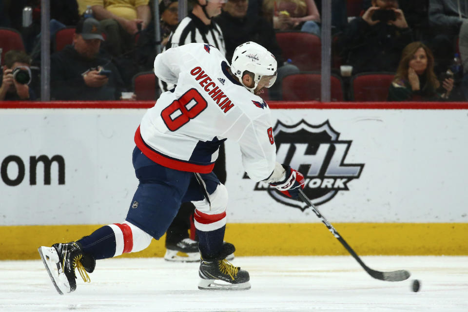 Washington Capitals left wing Alex Ovechkin shoots the puck against the Arizona Coyotes during the second period of an NHL hockey game Saturday, Feb. 15, 2020, in Glendale, Ariz. (AP Photo/Ross D. Franklin)