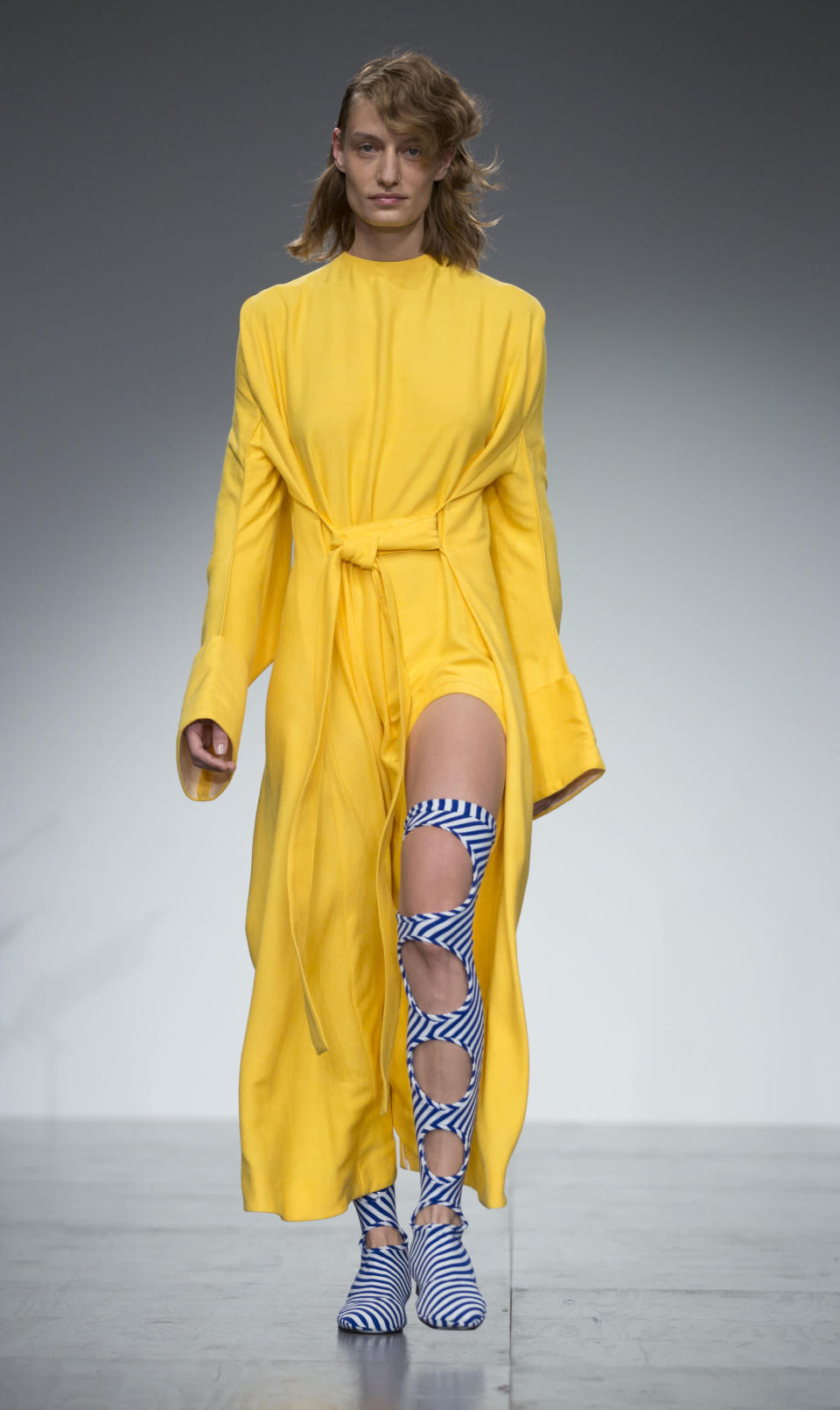 <p>Over at Richard Malone, models also stepped out in yellow. When shopping for the hue, opt for supersized sleeves and wrap-around silhouettes. <em>[Photo: PA]</em> </p>