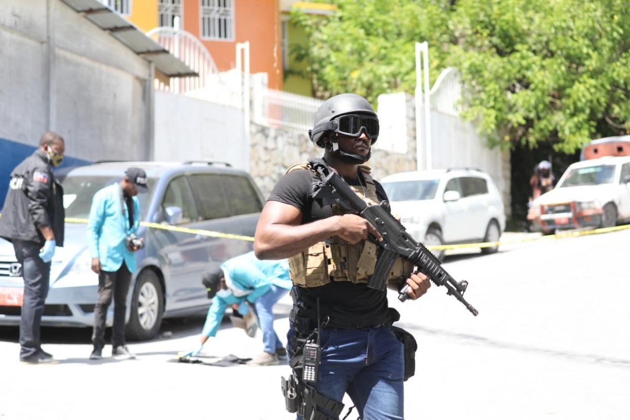 Members of the Haitian police and forensics look for evidence outside of the presidential residence  (AFP via Getty Images)