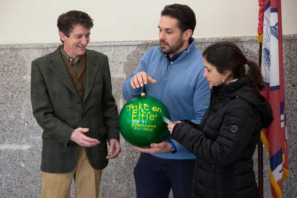 Brad and Jennifer Greer are presented with the “Take an Elfie” award for best downtown business for Greer Real Estate Group in the Light Up Jackson contest by Mayor Scott Conger on Monday, January 9, 2023, at city hall in Jackson, Tenn. 