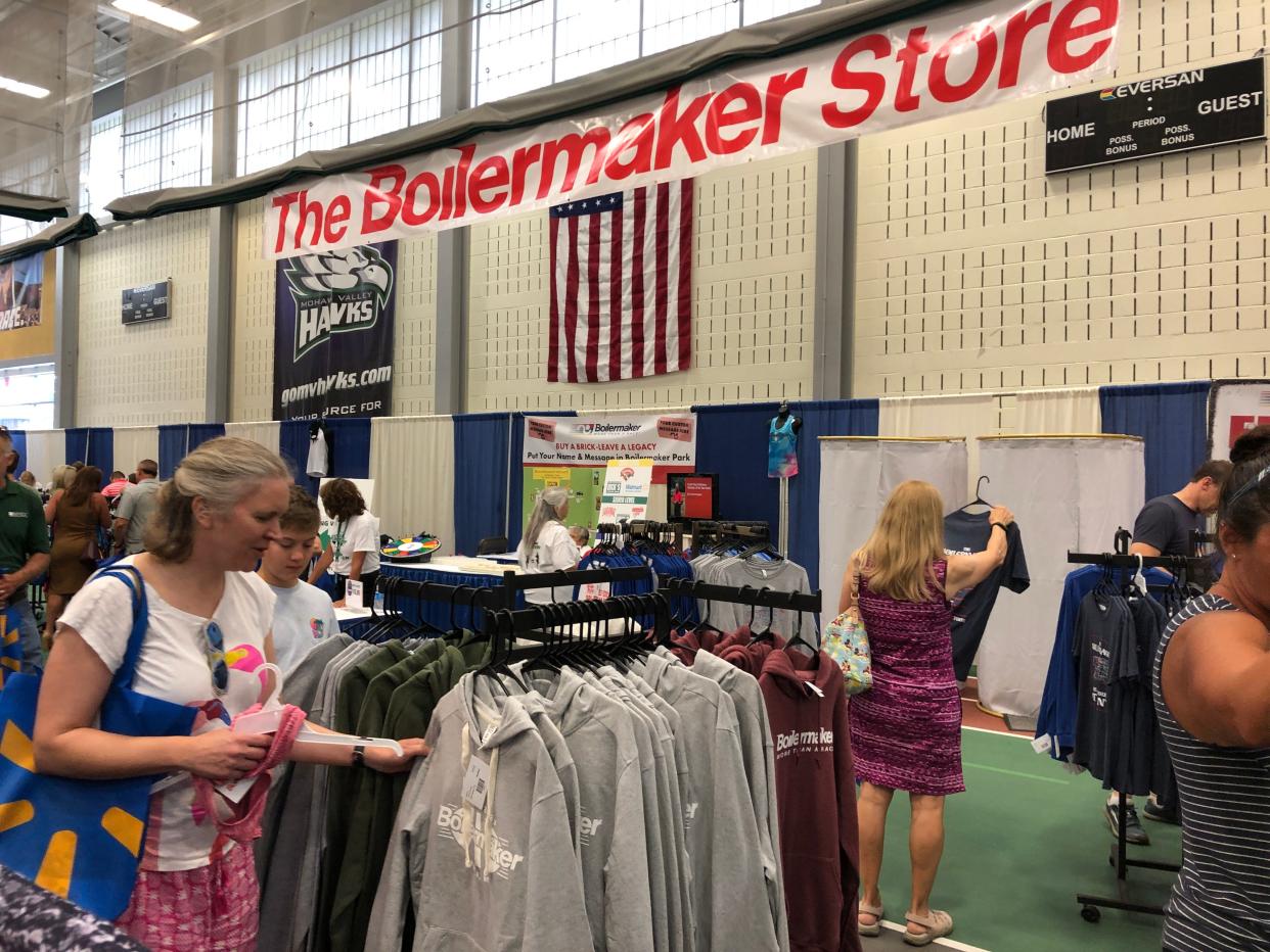 Shoppers browse Boilermaker merchandise and running gear in the Boilermaker Store at the Boilermaker Health and Wellness Expo at Mohawk Valley Community College in Utica on Friday, July 7, 2023.