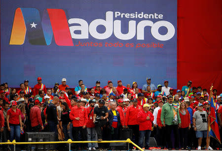 Venezuela's President Nicolas Maduro, his wife Cilia Flores and former Argentinian soccer player Diego Armando Maradona greet supporters during a campaign rally in Caracas, Venezuela May 17, 2018. REUTERS/Carlos Garcia Rawlins