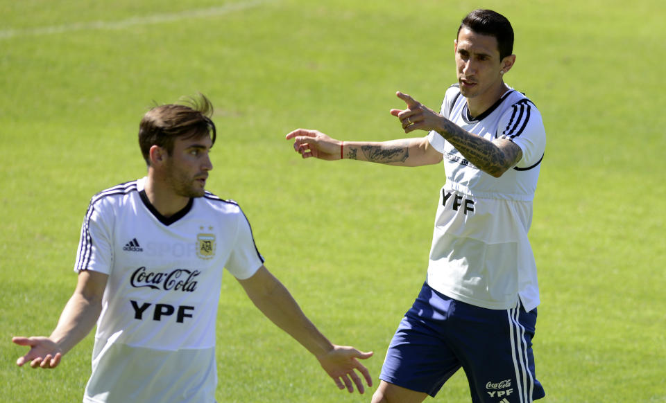 Argentina's Angel Di Maria, right, talks with teammate Nicolas Tagliafico during a practice session of the national soccer team in Belo Horizonte, Brazil, Tuesday, June 18, 2019. Argentina will face Paraguay tomorrow in a Copa America Group B soccer match. (AP Photo/Eugenio Savio)