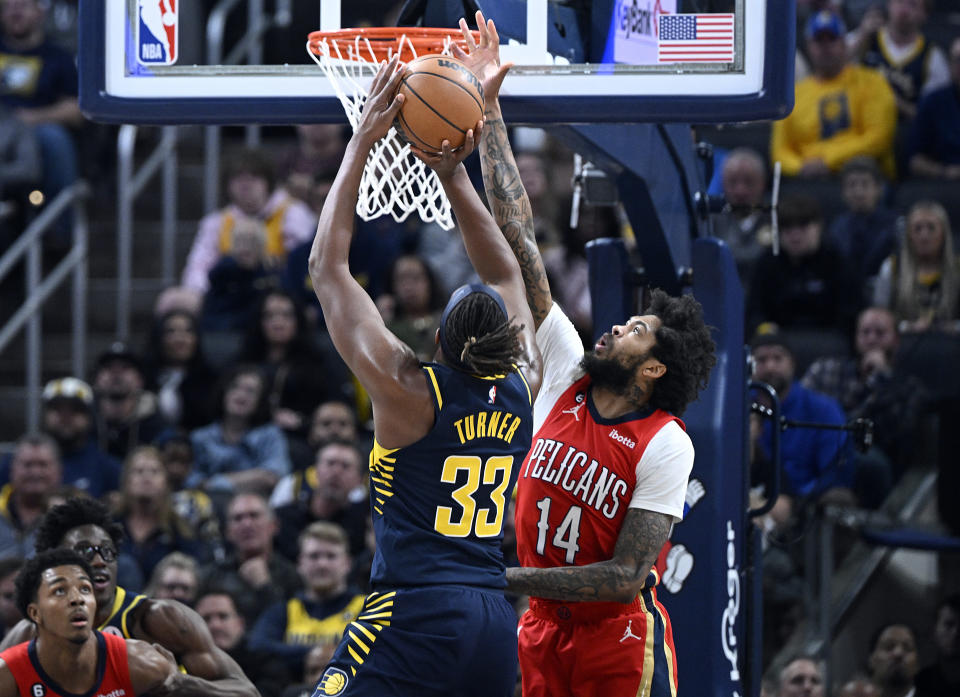 Indiana Pacers center Myles Turner (33) takes a shot past New Orleans Pelicans forward Brandon Ingram (14) during the second quarter of an NBA Basketball game, Monday, Nov. 7, 2022, in Indianapolis, Ind. (AP Photo/Marc Lebryk)