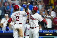 Philadelphia Phillies' Jean Segura (2) celebrates with Matt Vierling after Segura's home run off Miami Marlins' Braxton Garrett during the fourth inning of a baseball game Tuesday, Aug. 9, 2022, in Philadelphia. (AP Photo/Matt Rourke)