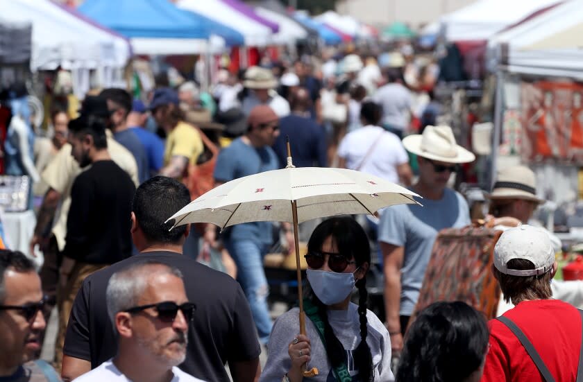 LONG BEACH, CALIF. - APR. 17, 2022. People look for vintage items and bargains at the Long Beach Flea Market on Sunday, Apr. 17, 2022. (Luis Sinco / Los Angeles Times)