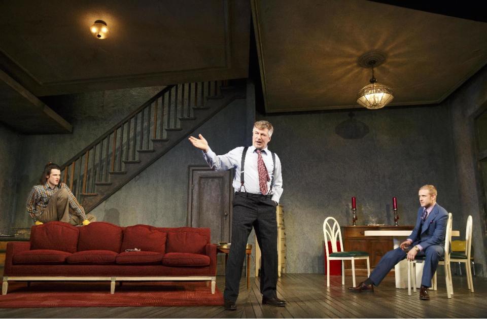 This theater image released by Boneau/Bryan-Brown shows, from left, Tom Sturridge, Alec Baldwin, and Ben Foster during a performance of "Orphans," at the Gerald Schoenfeld Theatre in New York. (AP Photo/Boneau/Bryan-Brown, Joan Marcus)