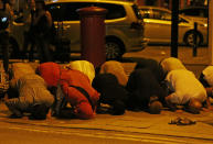 <p>Men pray after a vehicle collided with pedestrians near a mosque in the Finsbury Park neighborhood of North London, Britain June 19, 2017. (Neil Hall/Reuters) </p>