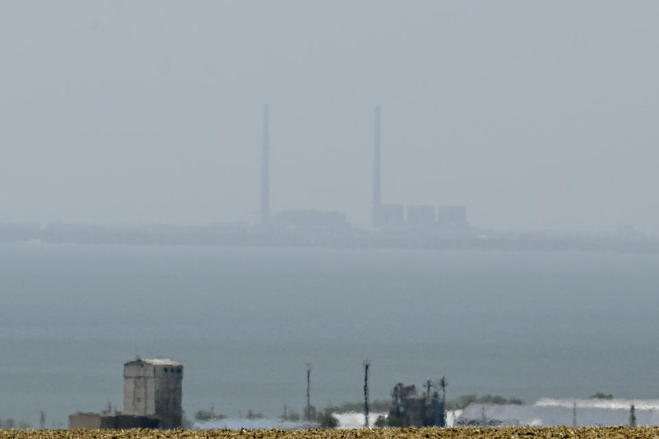 TOPSHOT - This photograph taken on August 13, 2022 from Vyschetarasivka shows the Zaporizhzhia nuclear power plant (Background-C) across the Dnipro river. - Ukraine remains deeply scarred by the 1986 Chernobyl nuclear catastrophe, when a Soviet-era reactor exploded and streamed radiation into the atmosphere in the country's north. The Zaporizhzhia nuclear power plant in southern Ukraine was occupied in the early days of the war and it has remained in Russian hands ever since. - To go with AFP Focus 