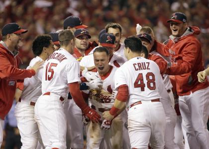 Kolten Wong is congratulated after hitting a walk-off home run during the ninth inning in Game 2. (AP)