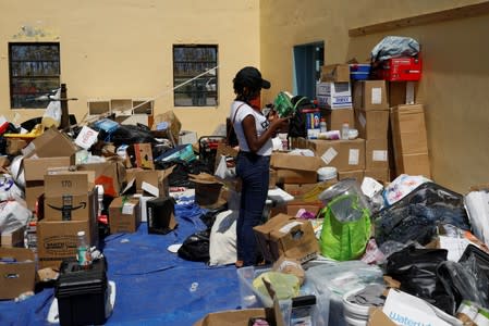 A volunteer looks for supplies at an airport during an evacuation operation after Hurricane Dorian hit the Abaco Islands in Treasure Cay