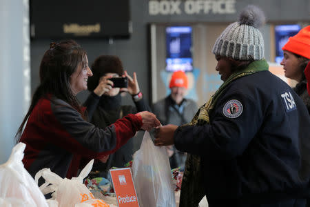 A Transportation Security Administration (TSA) employee receives a donation at a food distribution center for federal workers impacted by the government shutdown, at the Barclays Center in the Brooklyn borough of New York, U.S., January 22, 2019. REUTERS/Brendan McDermid