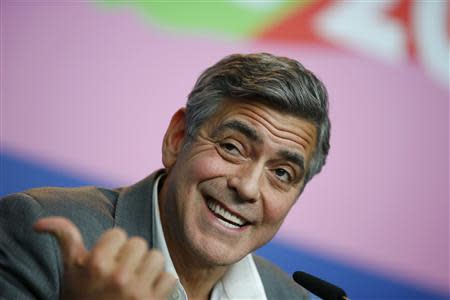 Cast member and director George Clooney reacts during a news conference to promote the movie 'The Monuments Men' at the 64th Berlinale International Film Festival in Berlin February 8, 2014. REUTERS/Thomas Peter