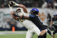 Notre Dame tight end Michael Mayer (87) makes a catch over BYU defensive back Micah Harper (1) during the first half of an NCAA college football game Saturday, Oct. 8, 2022, in Las Vegas. (AP Photo/John Locher)