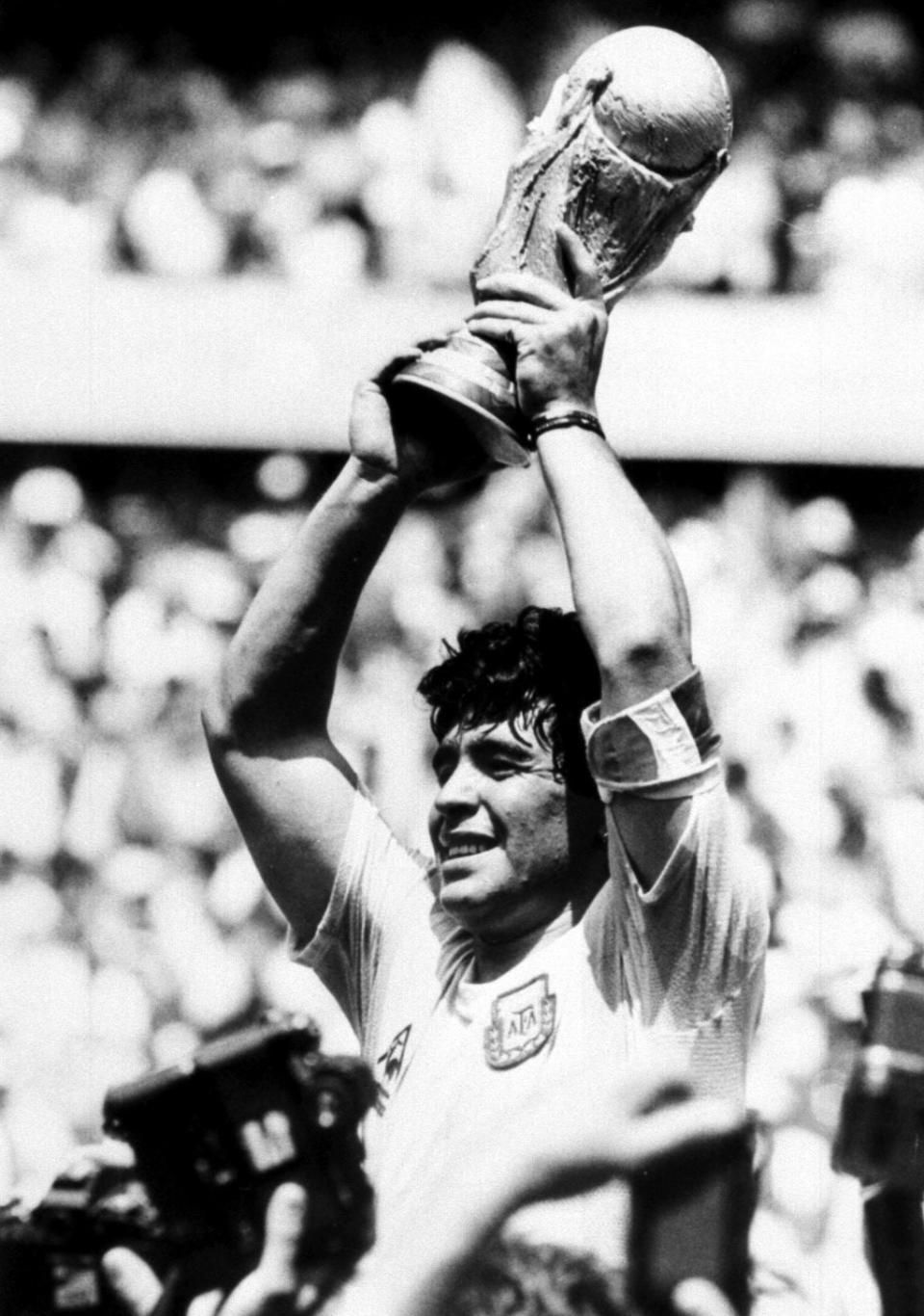 Diego Maradona holds up the World Cup after Argentina beat West Germany in the World Cup final in Mexico in 1986 (PA) (PA Archive)